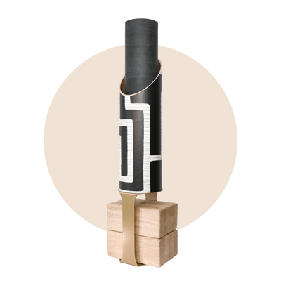 Colony tube and rolled black mat displayed on the wooden base with a contrasting tan support strap.