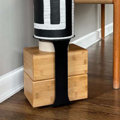 Close-up of the Colony tube mounted above four natural wood blocks with a wide black support strap.