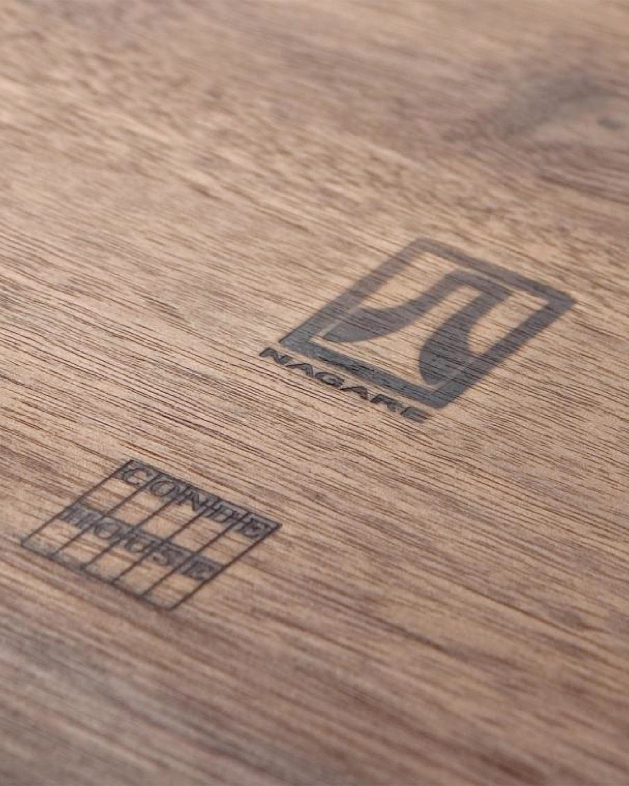 Close-up of walnut grain and craftsmanship on NAGARE Armchair