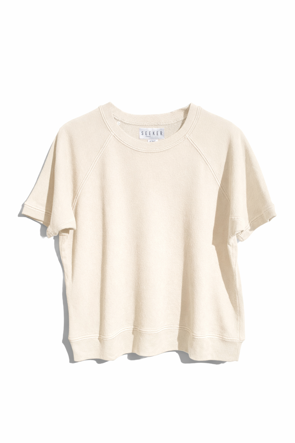 Front product view of the cream short-sleeve raglan shirt.