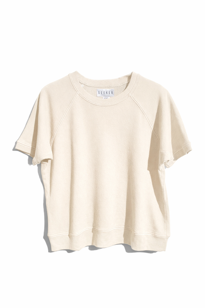 Front product view of the cream short-sleeve raglan shirt.