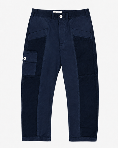 Front product view of navy Trek pants with dark tonal panels and a buttoned cargo pocket.