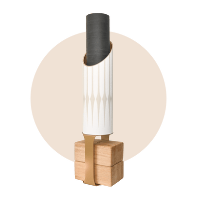 Gather storage tube with a black rolled mat on a pale wood base, framed by a soft beige circle.