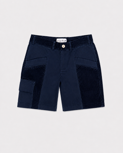 Front product view of navy Trek Shorts with dark tonal panels and a buttoned cargo pocket.