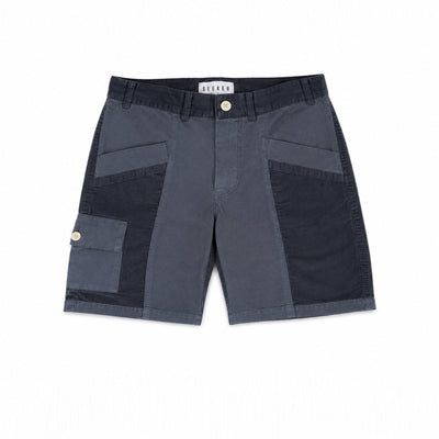 Front product view of slate-blue Trek Shorts with dark tonal panels and a buttoned cargo pocket.