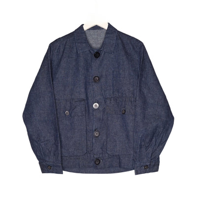 Front product view of the dark indigo Studio Coat with a pointed collar, button closure, and two large flap pockets.