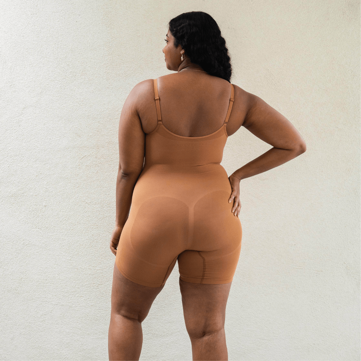 Back view of shapewear bodysuit highlighting sculpting fit and seamless design