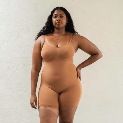 Model wearing plant-based shapewear bodysuit in nude with light compression and smoothing fit