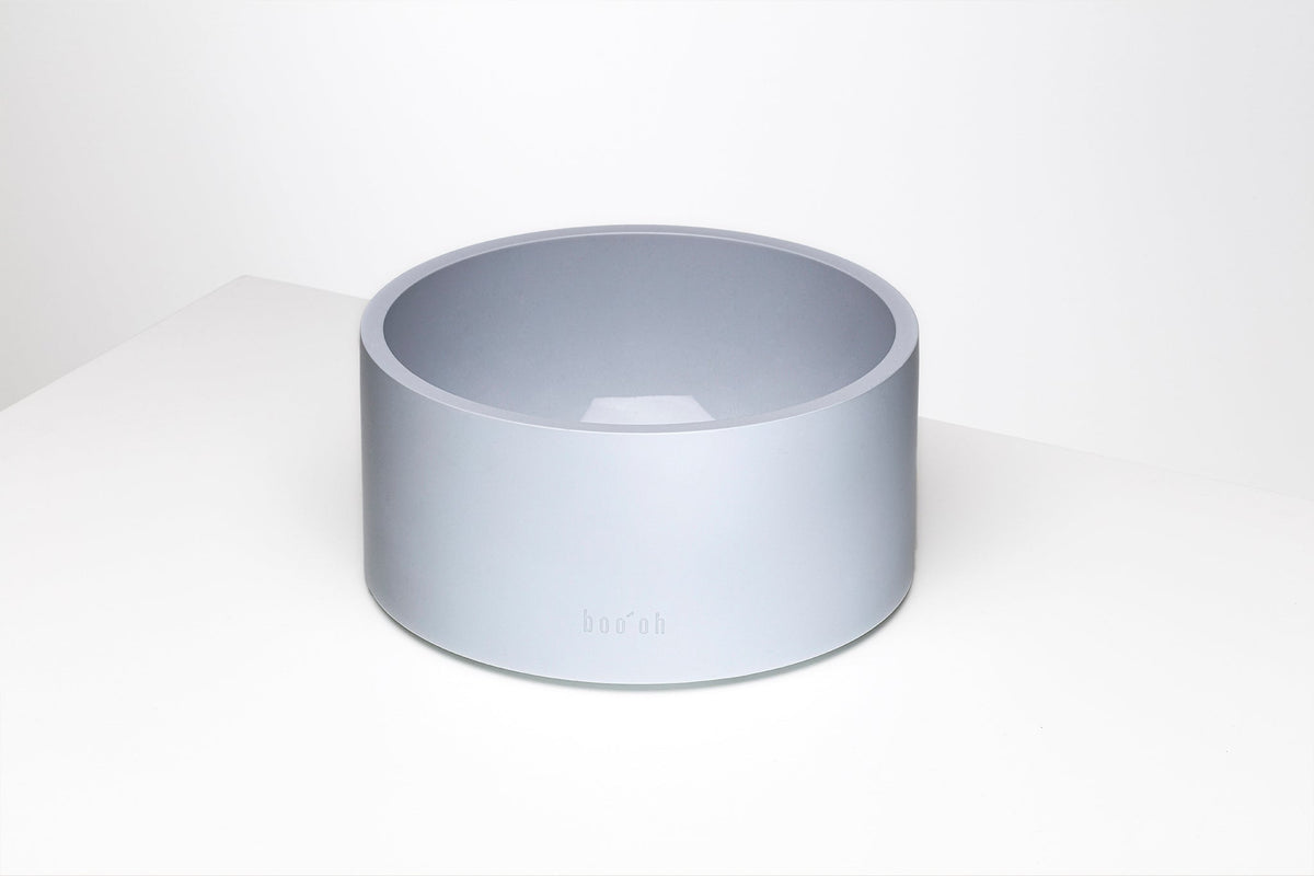 Minimalist pale blue-gray pet bowl with a deep round basin, thick rim, straight cylindrical sides, and a small Boo Oh logo near the base.