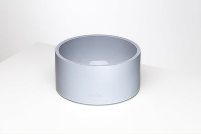 Minimalist pale blue-gray pet bowl with a deep round basin, thick rim, straight cylindrical sides, and a small Boo Oh logo near the base.