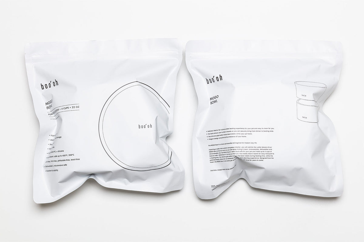 Two white drawstring storage bags printed with Boo Oh product information and simple bowl illustrations.