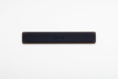 Slim matte-black Mogo Spatula laid horizontally, with a low-profile rounded rectangular shape and small Boo Oh logo centered on the handle.