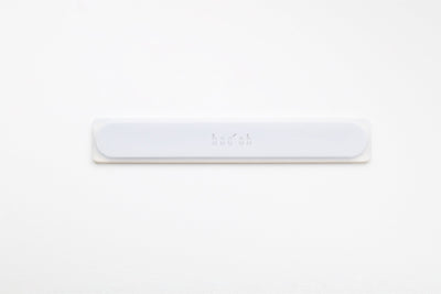 Slim white Mogo Spatula laid horizontally, with a low-profile rounded rectangular shape and subtle Boo Oh logo centered on the handle.