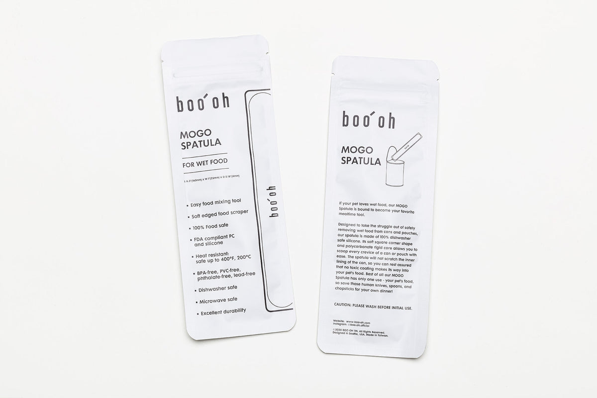 Two white Boo Oh storage pouches printed with product information for the Mogo Spoon and Mogo Spatula.