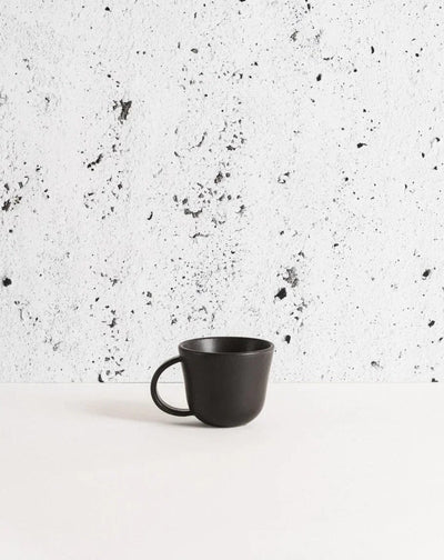Gharyan Stoneware Japandi Tableware Mug, Matte Black, against speckled background