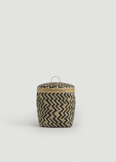 Small bamboo storage basket with a fitted lid, loop handle, and black-and-natural zigzag weave.