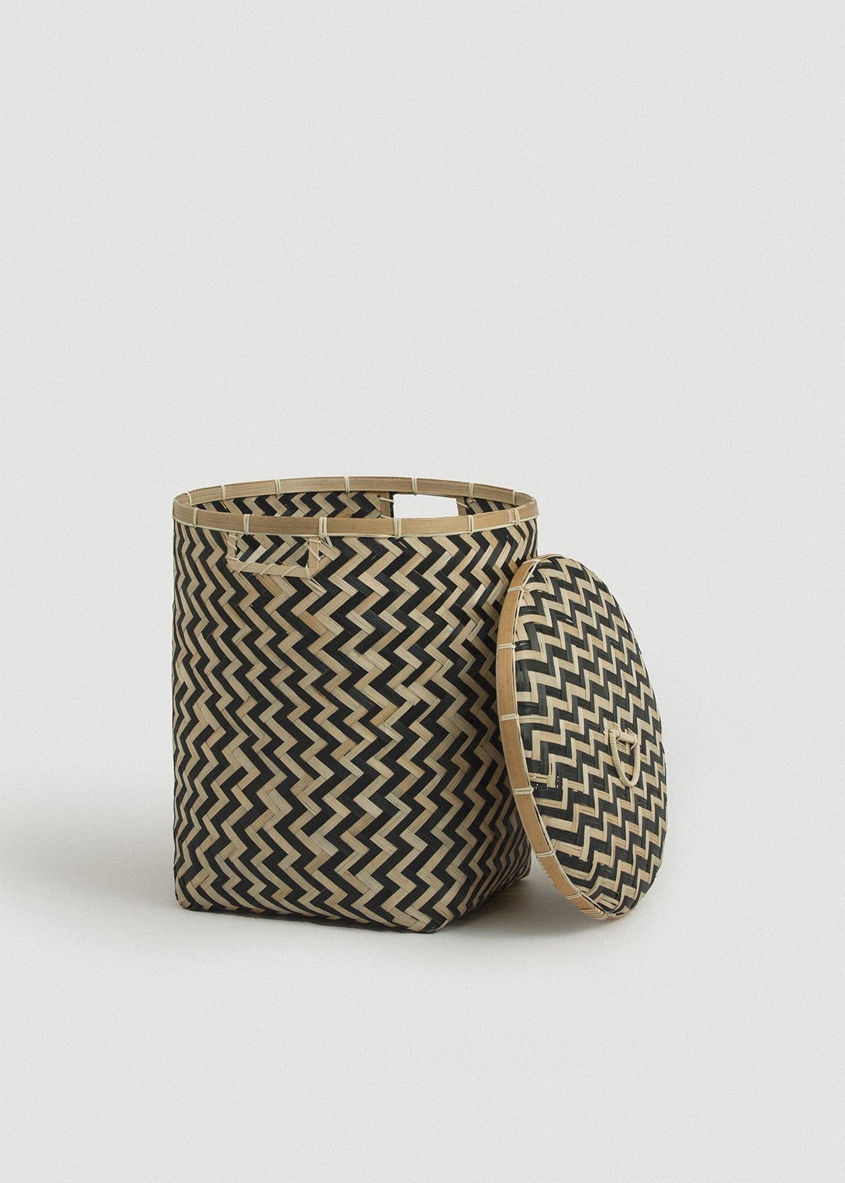 Open Java basket with the matching patterned lid leaning against its side.