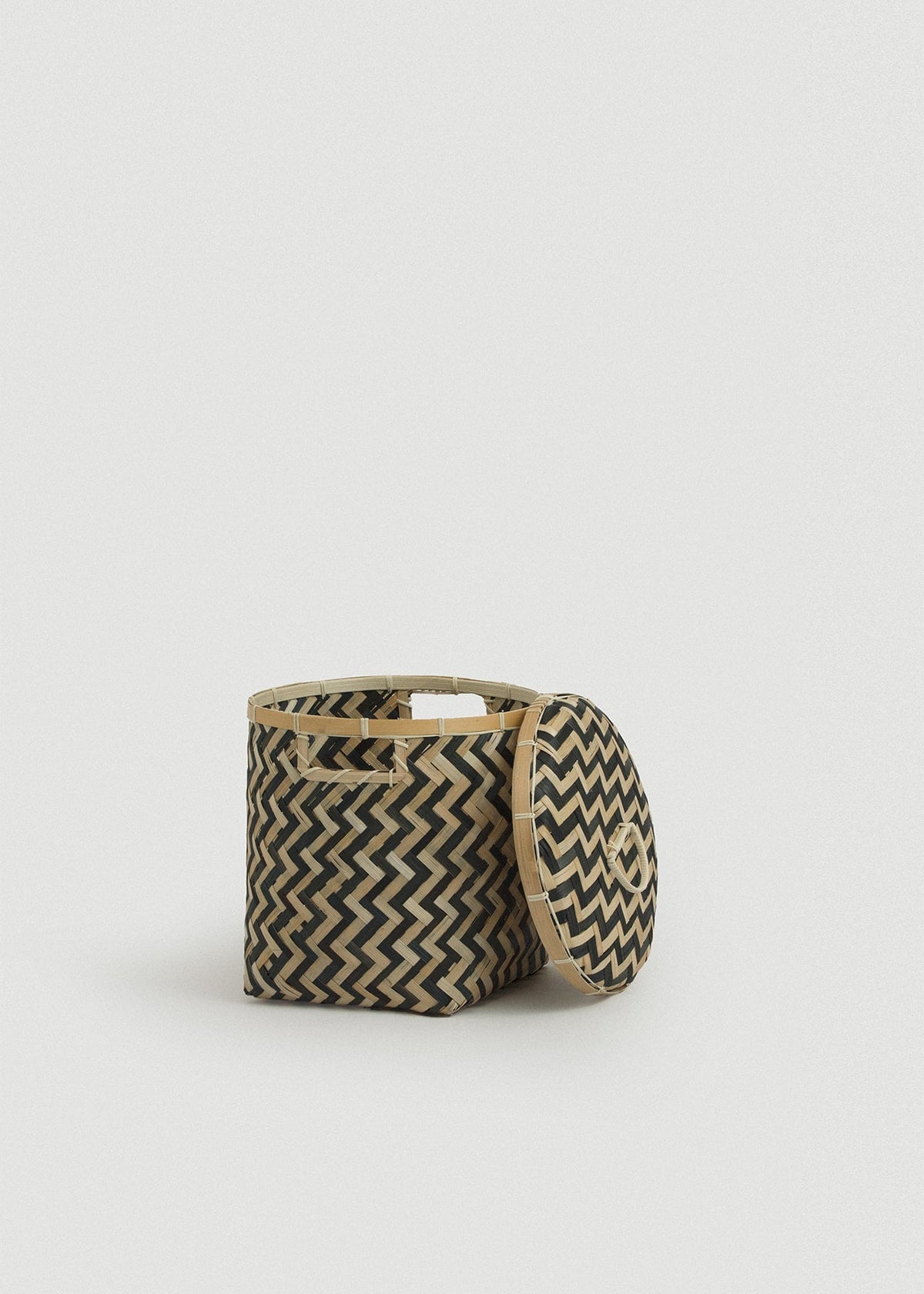 Open Java basket with the matching patterned lid leaning against its side.