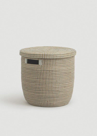 Natural woven seagrass storage basket with a flat fitted lid and rectangular black side handle.