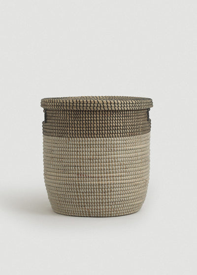 Front view of the Black Medina basket showing its rounded cylindrical shape and dark woven rim.