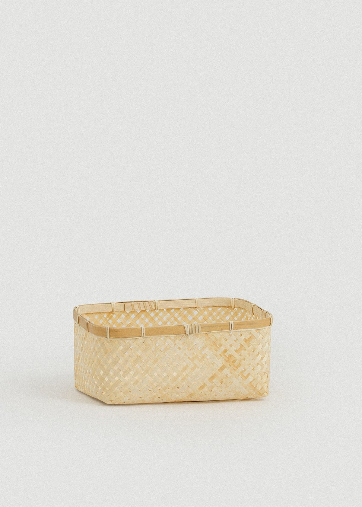 Small rectangular bamboo basket with an open lattice weave and reinforced rim.