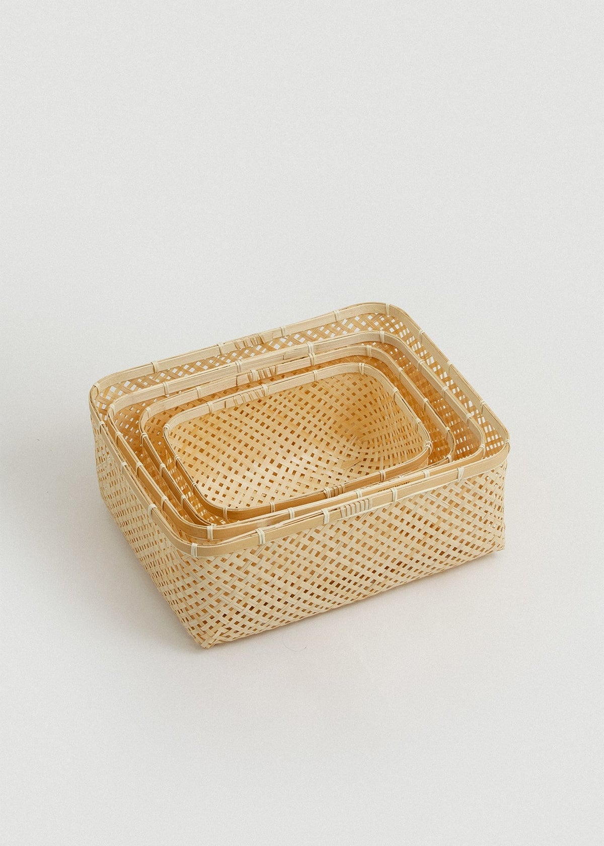 Four Muko rectangular baskets nested together to demonstrate compact storage.