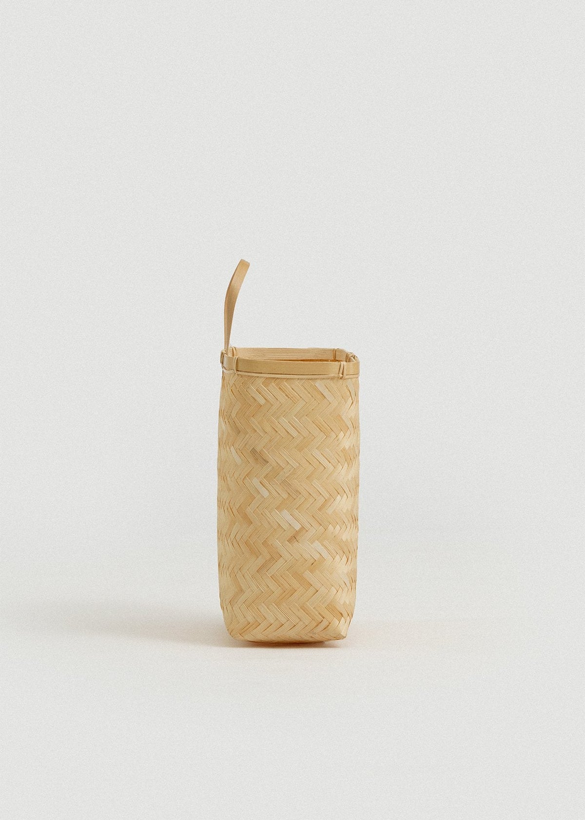 Side view highlighting the basket’s narrow depth and upright hanging handle.