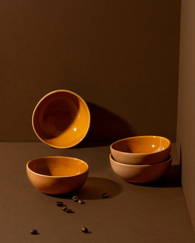 Stoneware bowls in Terracotta styled together on warm-toned background