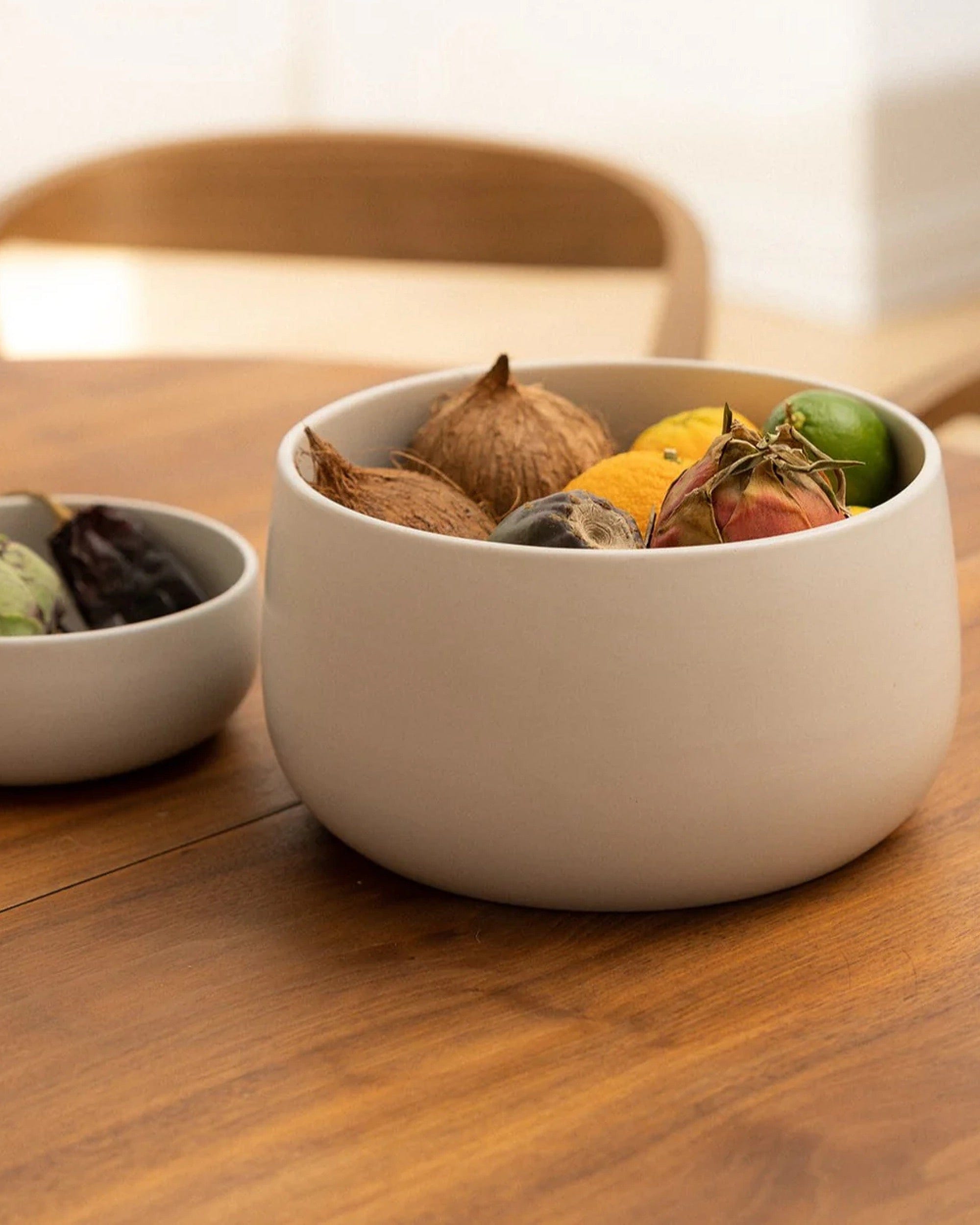 Stoneware serving bowl 120 oz filled with fruit on wood dining table