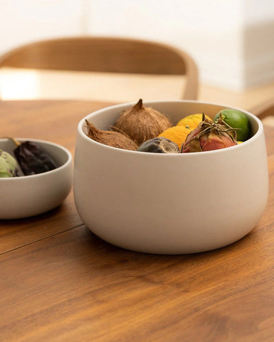Stoneware serving bowl 120 oz filled with fruit on wood dining table