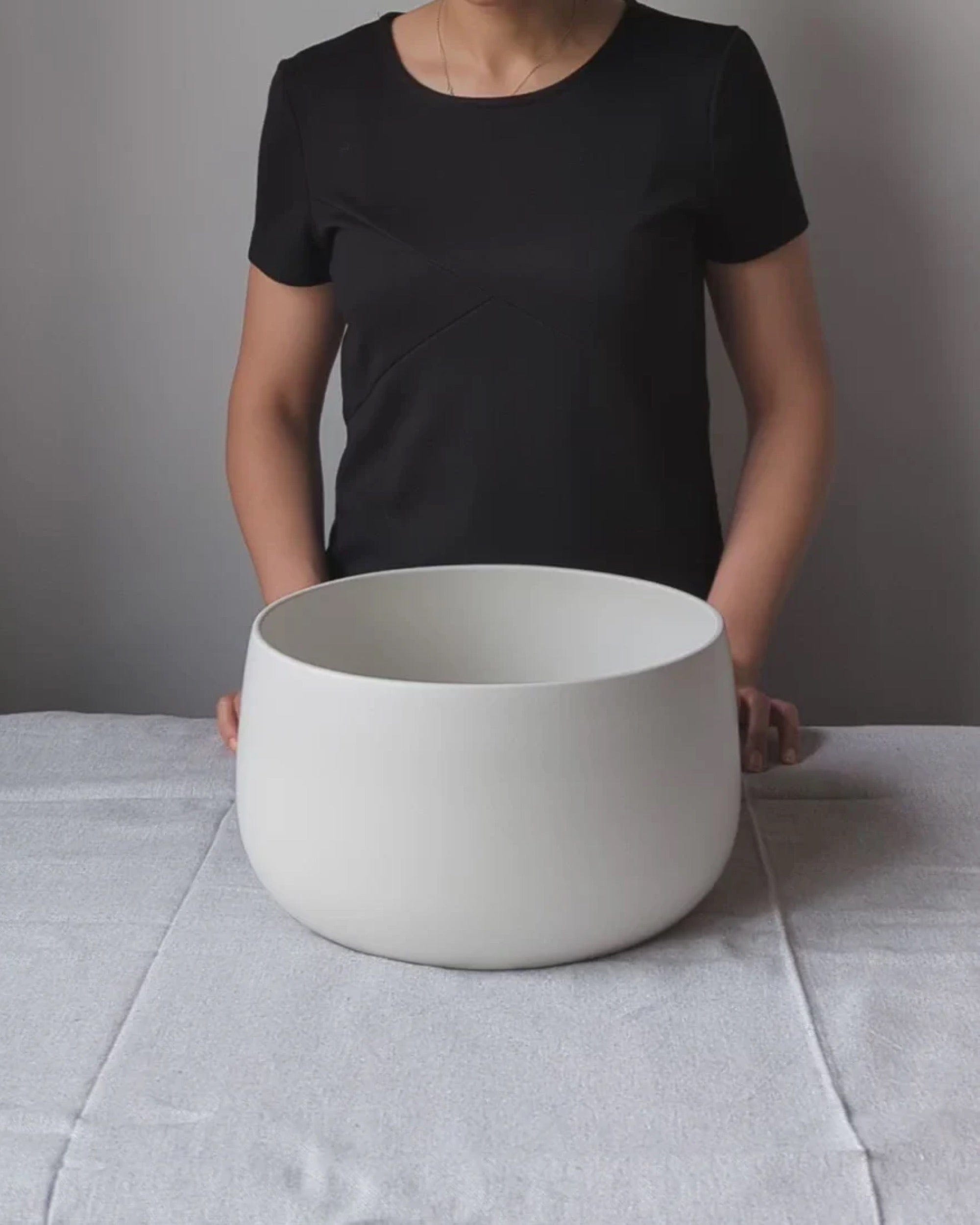 Person holding stoneware serving bowl 120 oz in Matte White to show scale