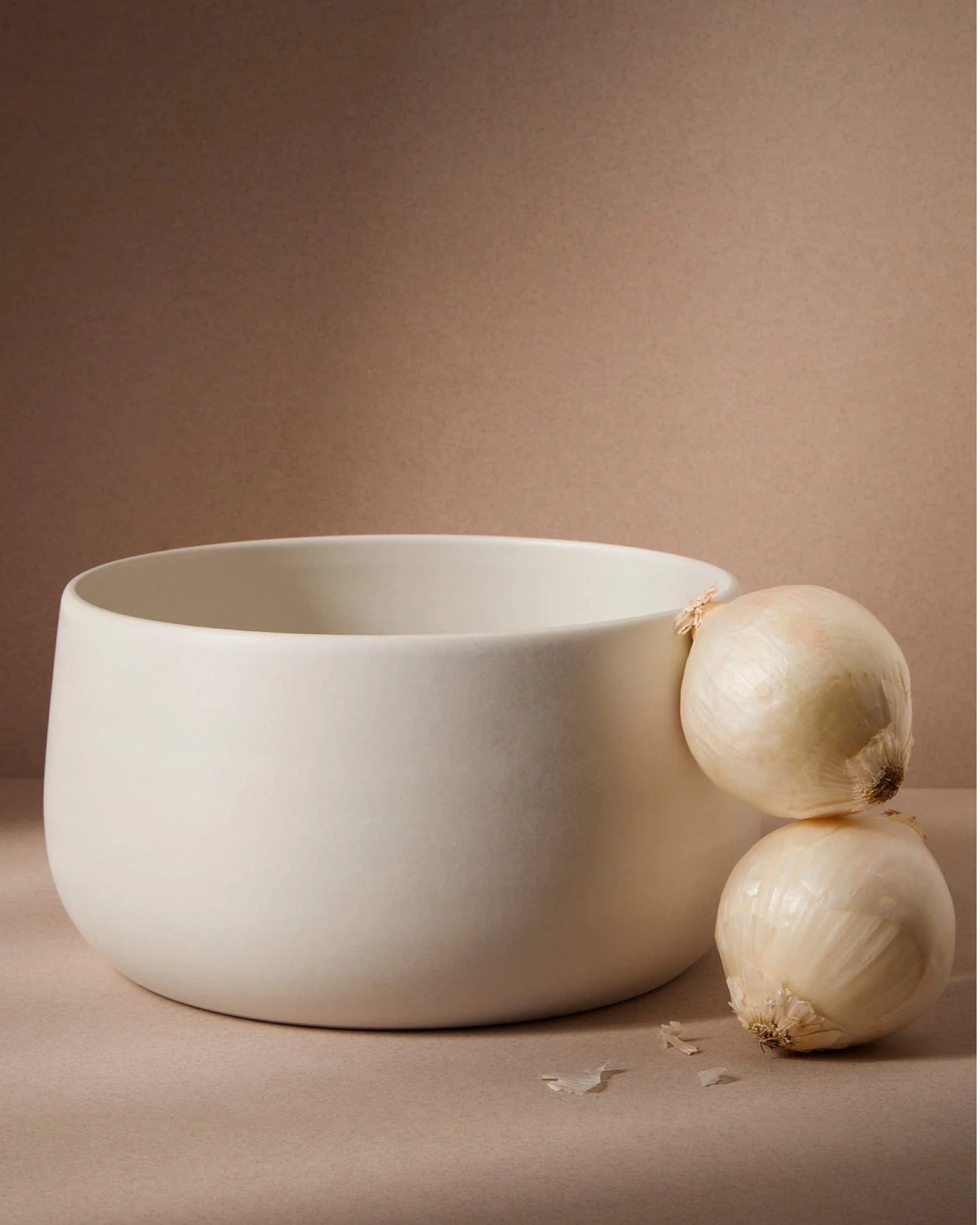 Stoneware serving bowl 120 oz in Matte White with onions on warm-toned background