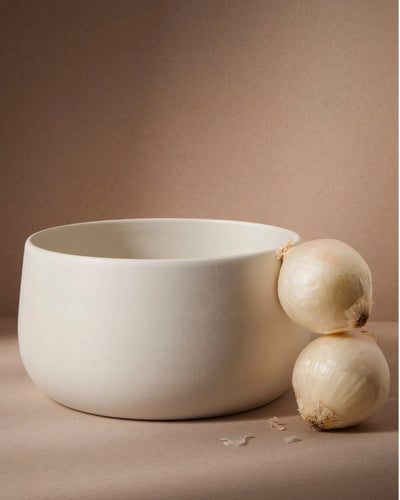 Stoneware serving bowl 120 oz in Matte White with onions on warm-toned background