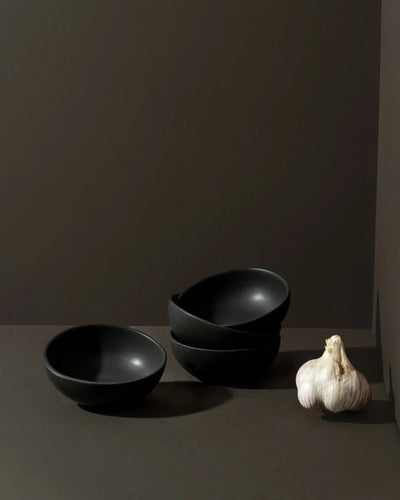 Stoneware bowls in Matte Black with garlic on dark background