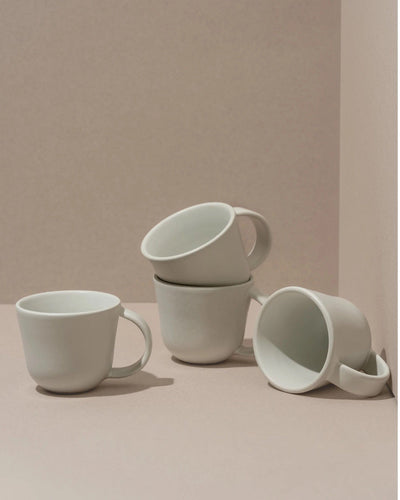Stoneware mugs in Matte White styled together on neutral background