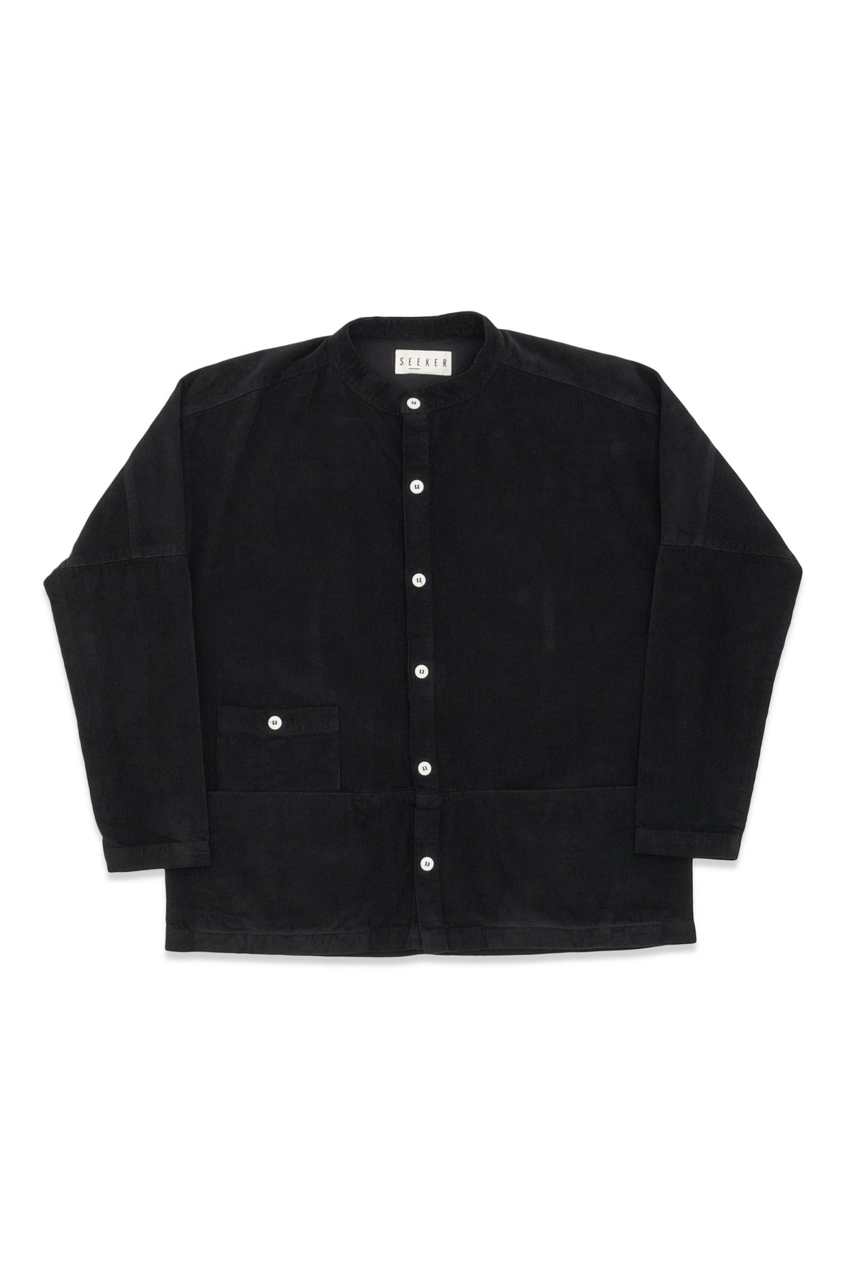 Front product view of the black Raj corduroy coat with white buttons and patch pockets.