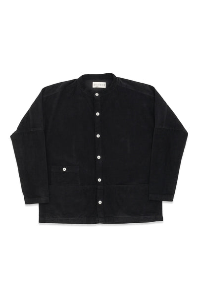 Front product view of the black Raj corduroy coat with white buttons and patch pockets.