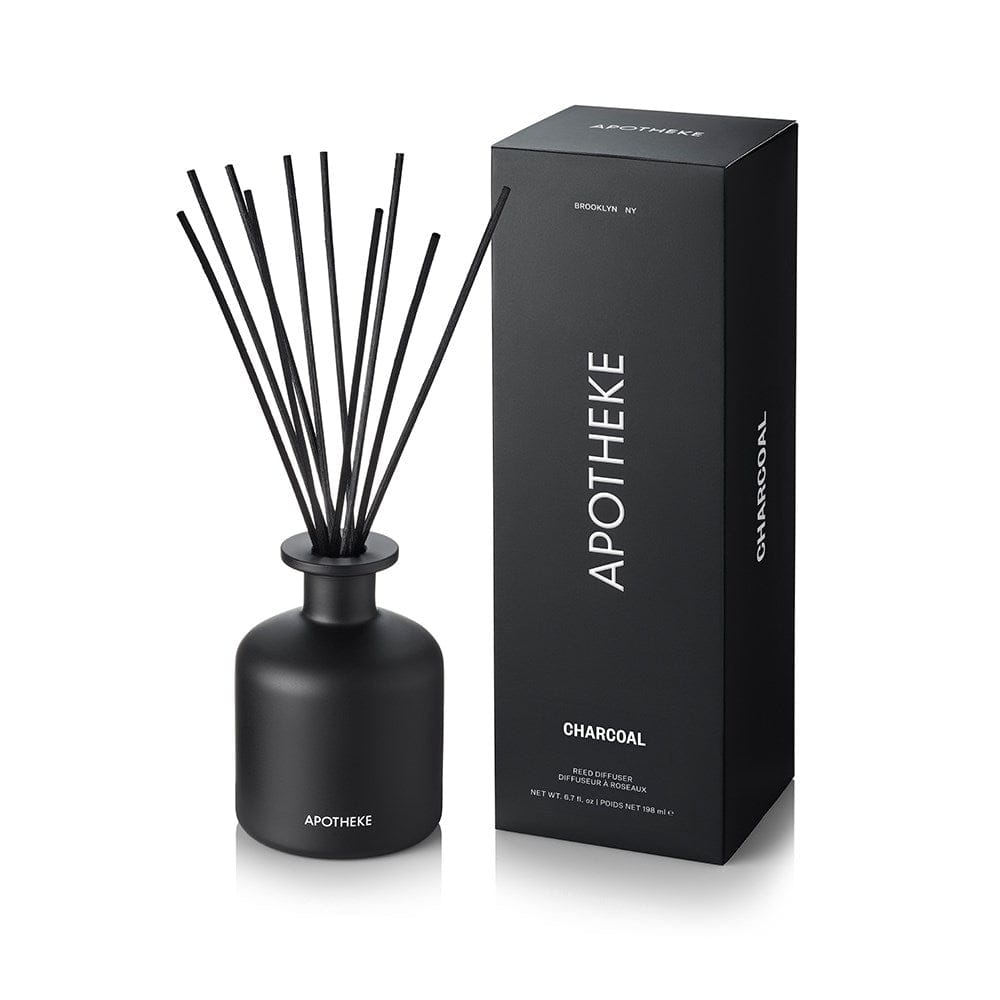 Charcoal Reed Diffuser in matte black glass with black rattan reeds beside APOTHEKE packaging box