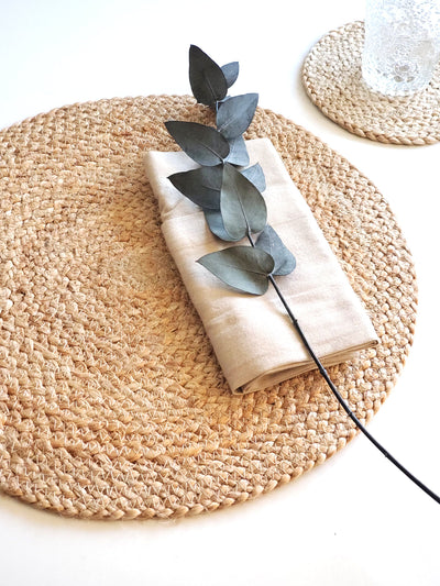 Korissa Kata Natural Placemat with linen napkin, eucalyptus sprig, and coaster
