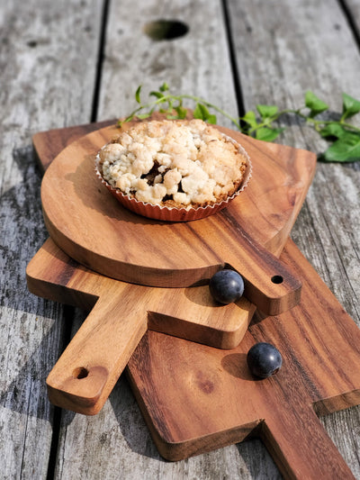 Korissa Wooden Round Serving Board with tart, blueberries, and greenery styled