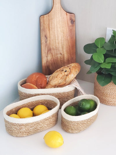 Korissa Savar Oval Bowl with cutting board, lemons, limes, plant