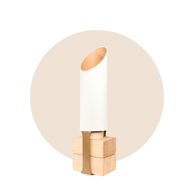 Full Sattva yoga mat tube and pale wood base displayed against a soft beige circular backdrop.