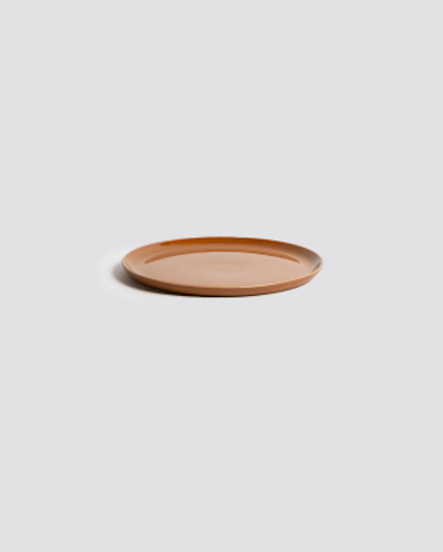 Stoneware side plate in Terracotta side profile view showing rim and glazed interior