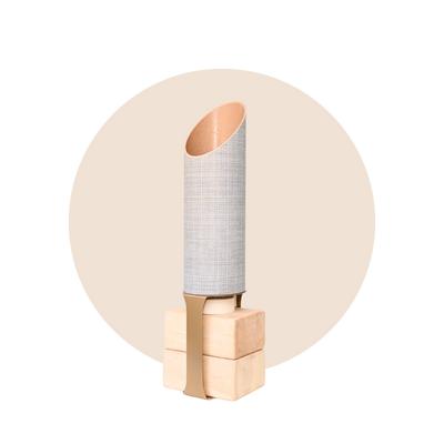 Full SeaWeave yoga mat tube and wooden block stand displayed against a pale beige circular backdrop.