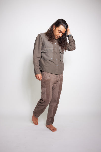 Barefoot model posing in the taupe-gray Trek Shirt and matching pants.