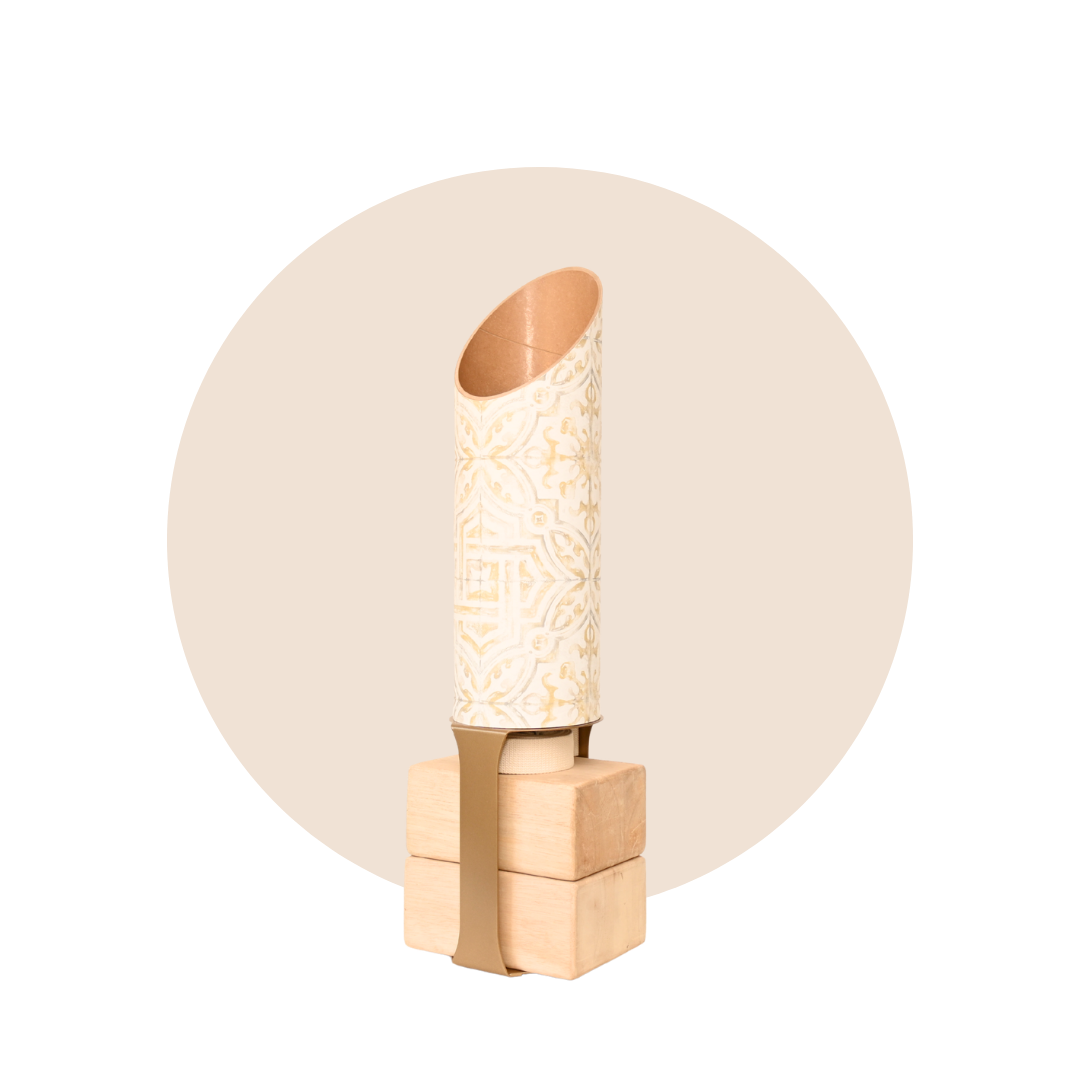 Full Star Crossed yoga mat tube and wooden block stand displayed against a beige circular backdrop.