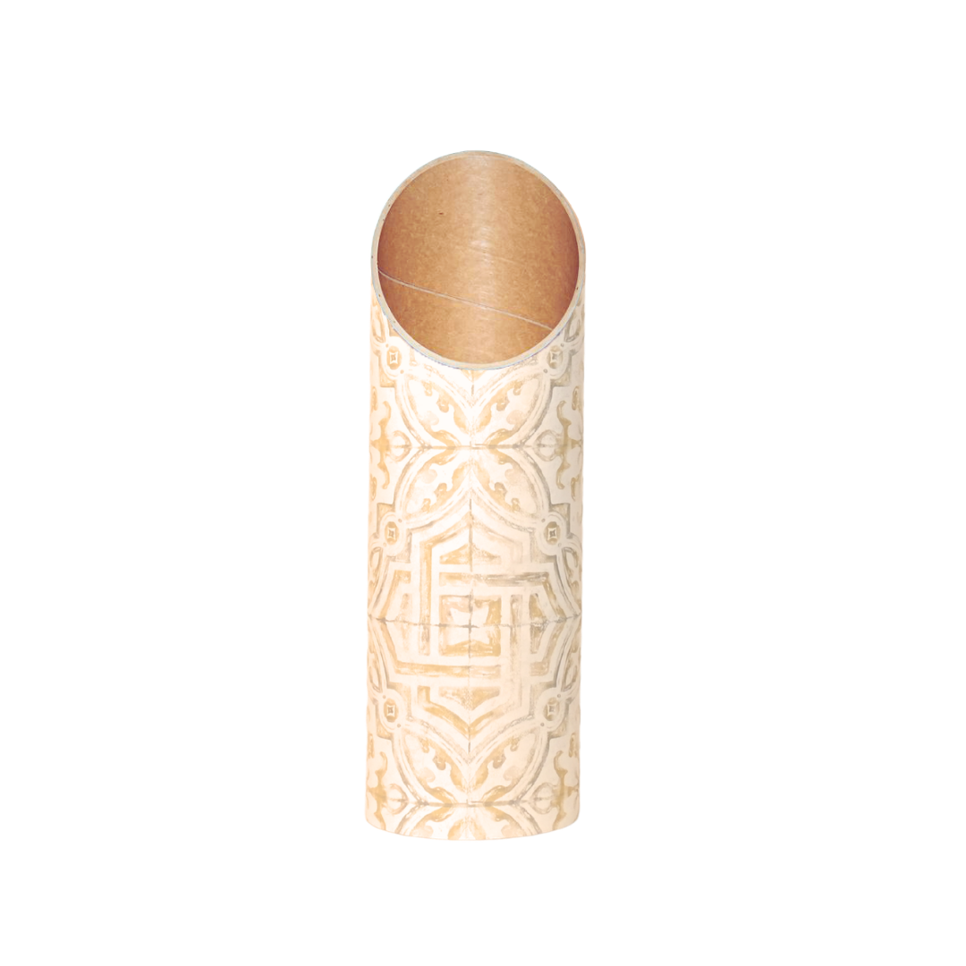 Front view of the slim cream tube with an intricate gold geometric pattern and warm tan interior.