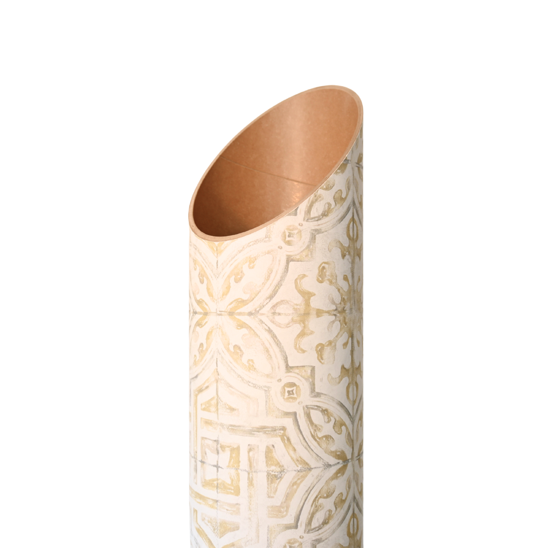Close-up of the tube’s angled open top, showing its copper-toned interior and embossed-looking gold pattern.