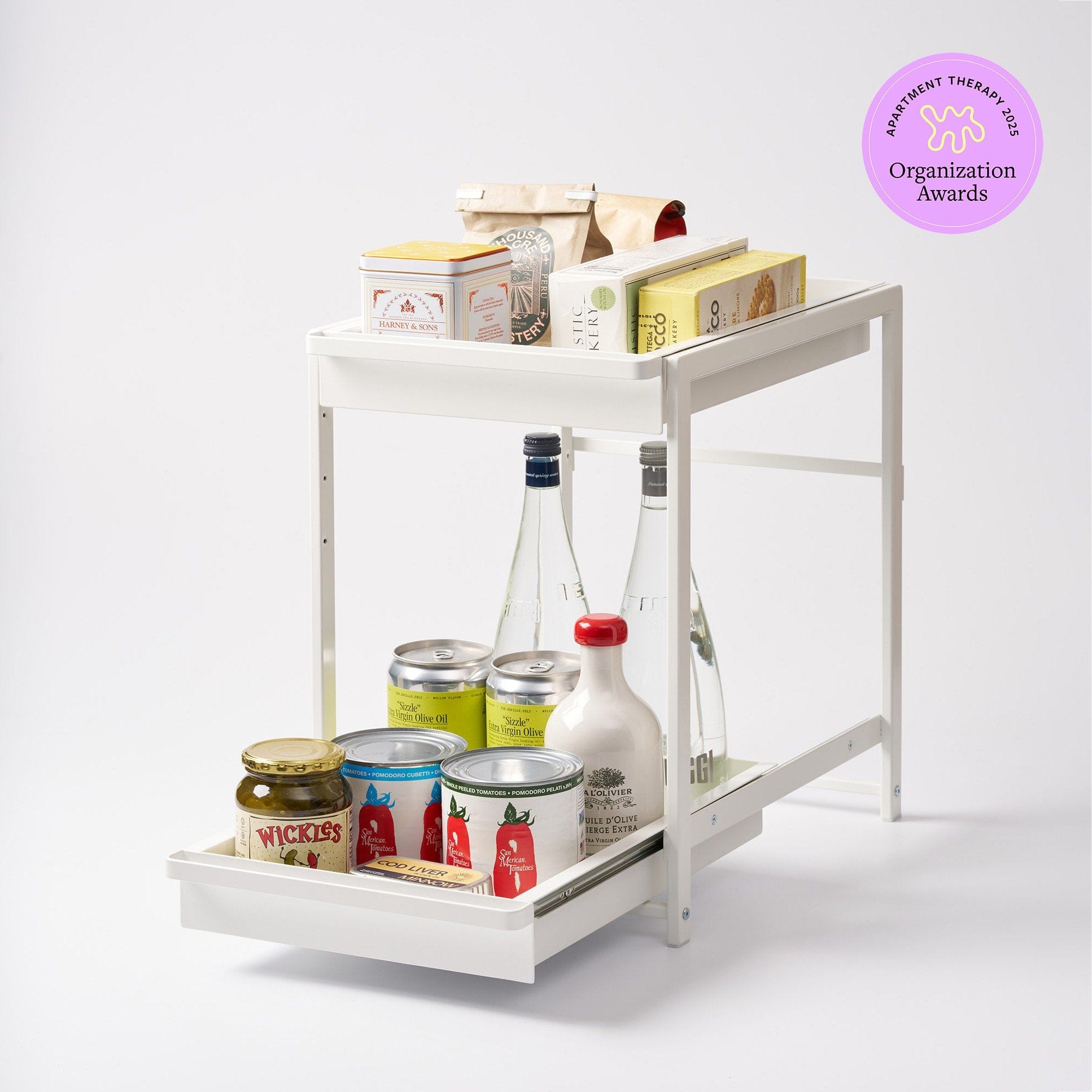 The Two-Tier Pull-Out Shelf is designed to bring order to under-sink cabinets, pantries, and utility spaces by making stored items easier to access and organize.