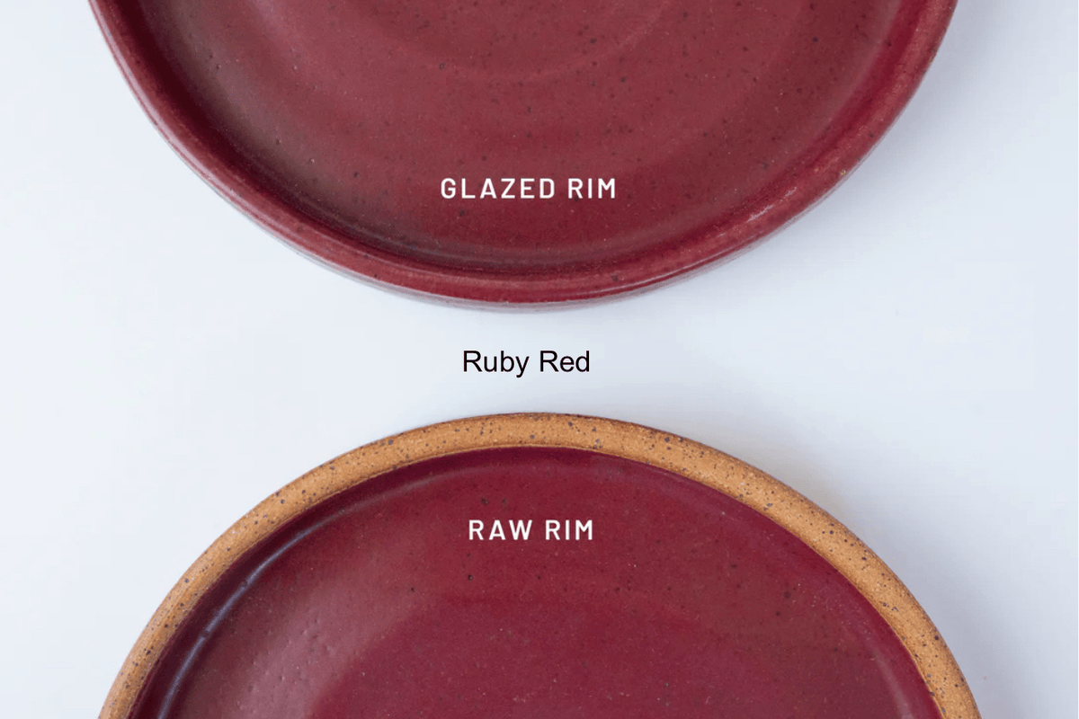 Two red ceramic plates with 'Glazed Rim' and 'Raw Rim' labels on a white background by KJ Pottery